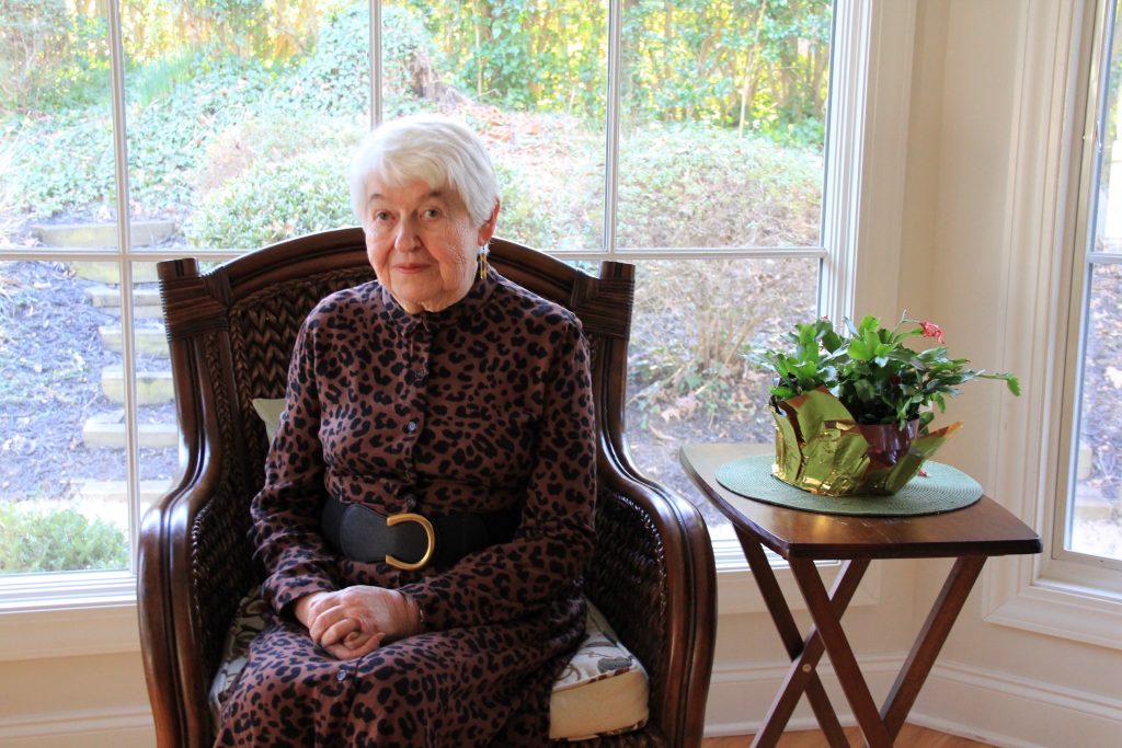 Peggy Cover sits in a chair in front of a window