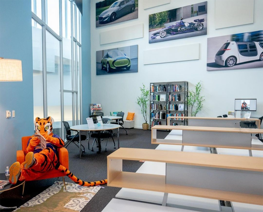 the clemson tiger reading a book at the CU-ICAR library