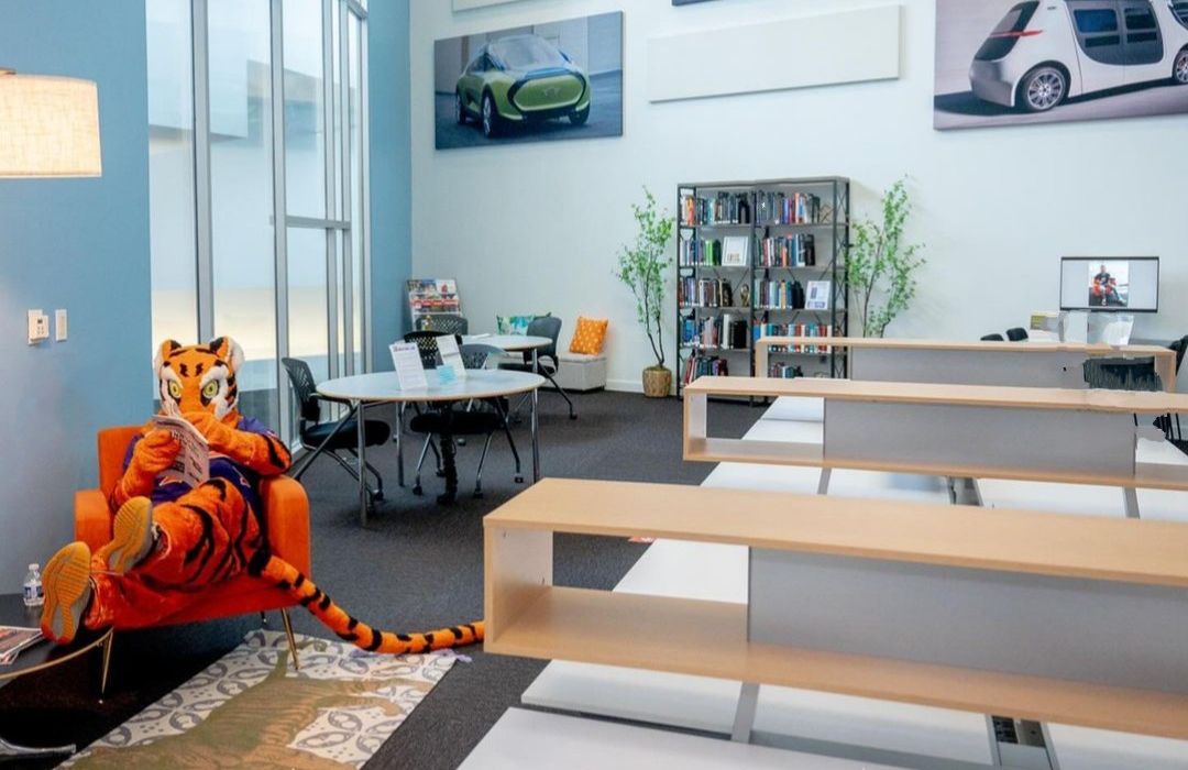 the clemson tiger reading a book at the CU-ICAR library