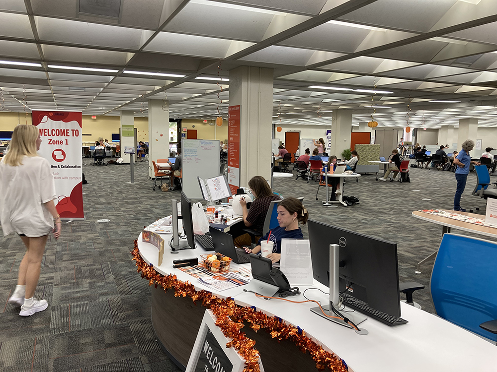 student workers sitting at the learning commons help desk.