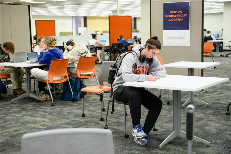 Student sitting at a table to receive career help in the learning commons.