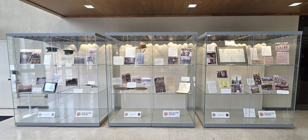 Glass display cases containing exhibits from the Special Collections and Archives for Summer 2026