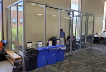 5th floor group study space featuring a table with chairs surrounded by glass walls