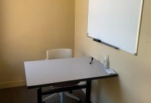 Individual study room with small whiteboard and capacity for 2
